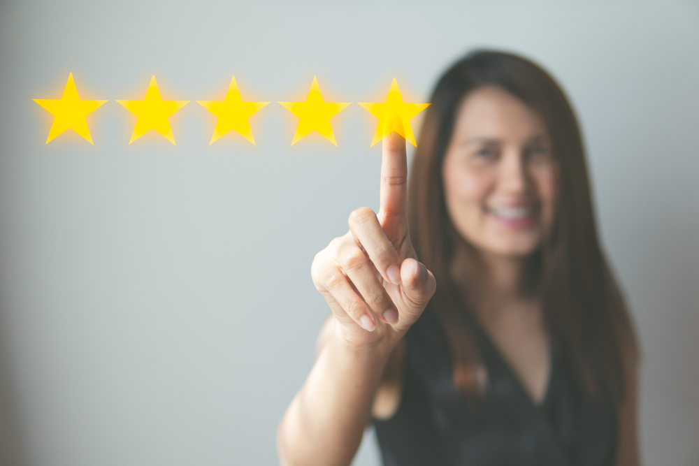 Girl pointing 5 star review
